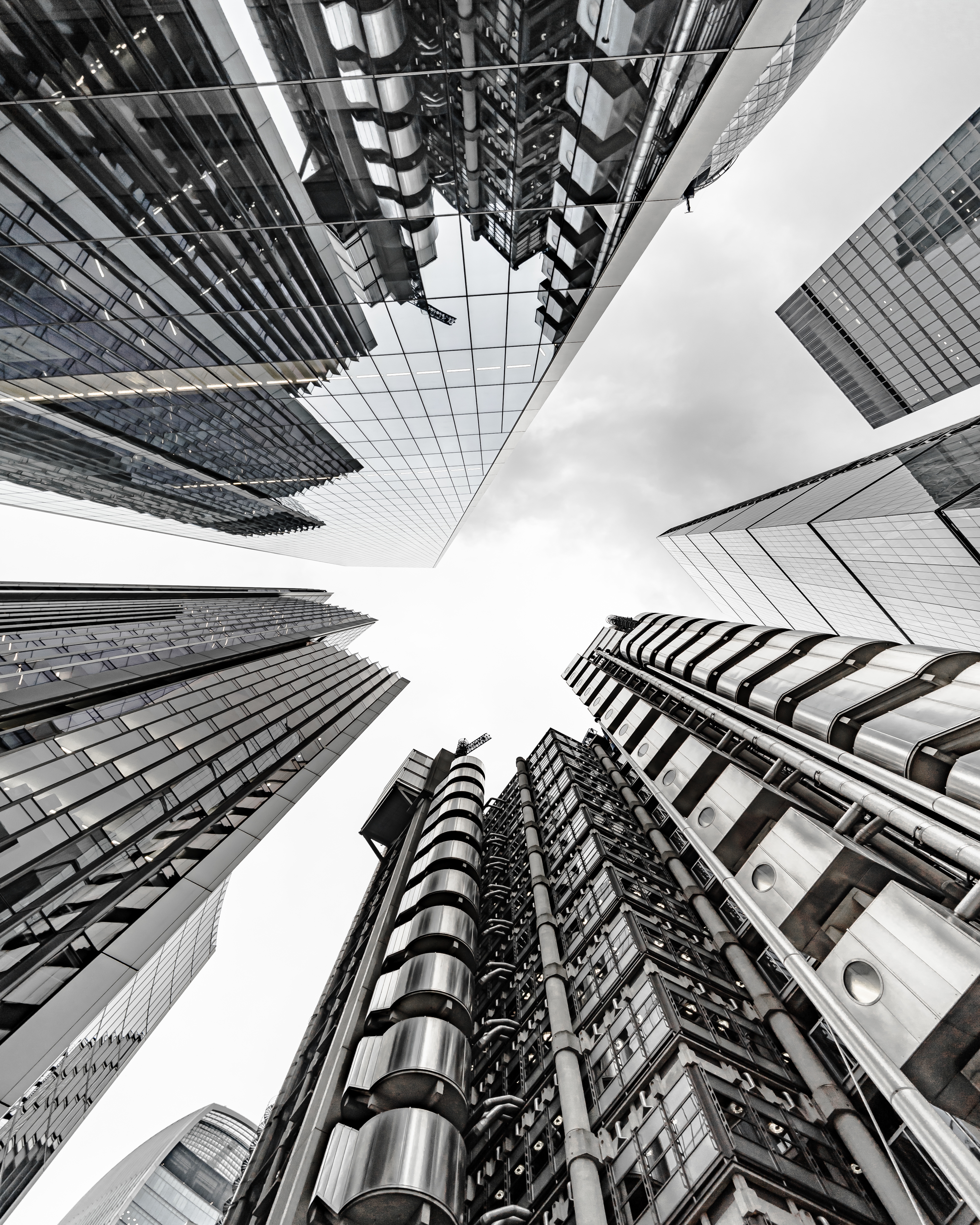 A vertical low angle shot of a modern business building scenery touching the sky